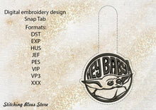 Load image into Gallery viewer, Baby Yoda with inscription hey baby Snap Tab machine embroidery design - Mandalorian